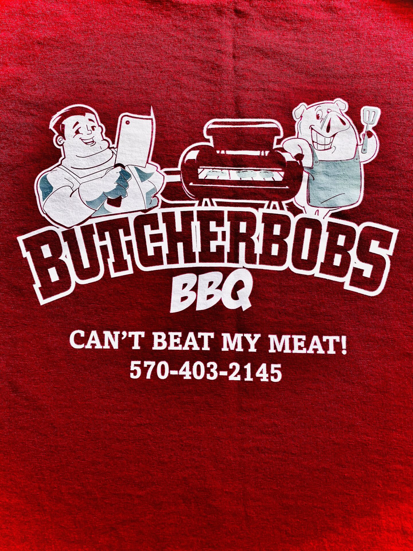 A red shirt with butcherbobs bbq logo on it.