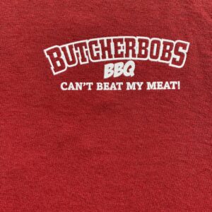 A red shirt that says butcherbob 's bbq can 't beat my meat