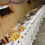 A long table with many different food items on it