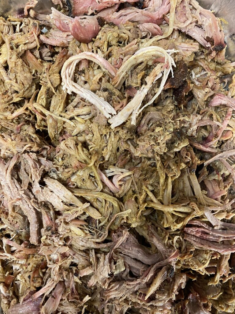 A pile of dried flowers with a heart shaped symbol on top.